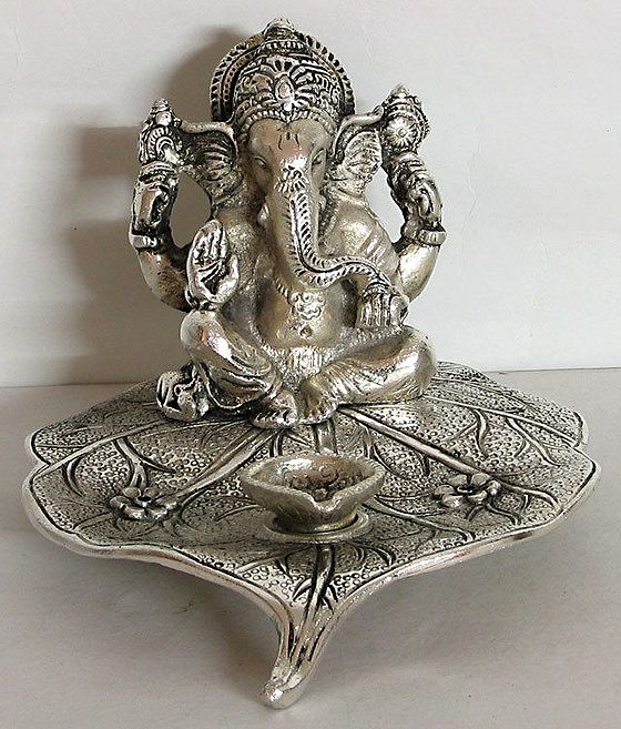 Ganesha Sitting on a Pipul Leaf with an Ghee or Oil Lamp